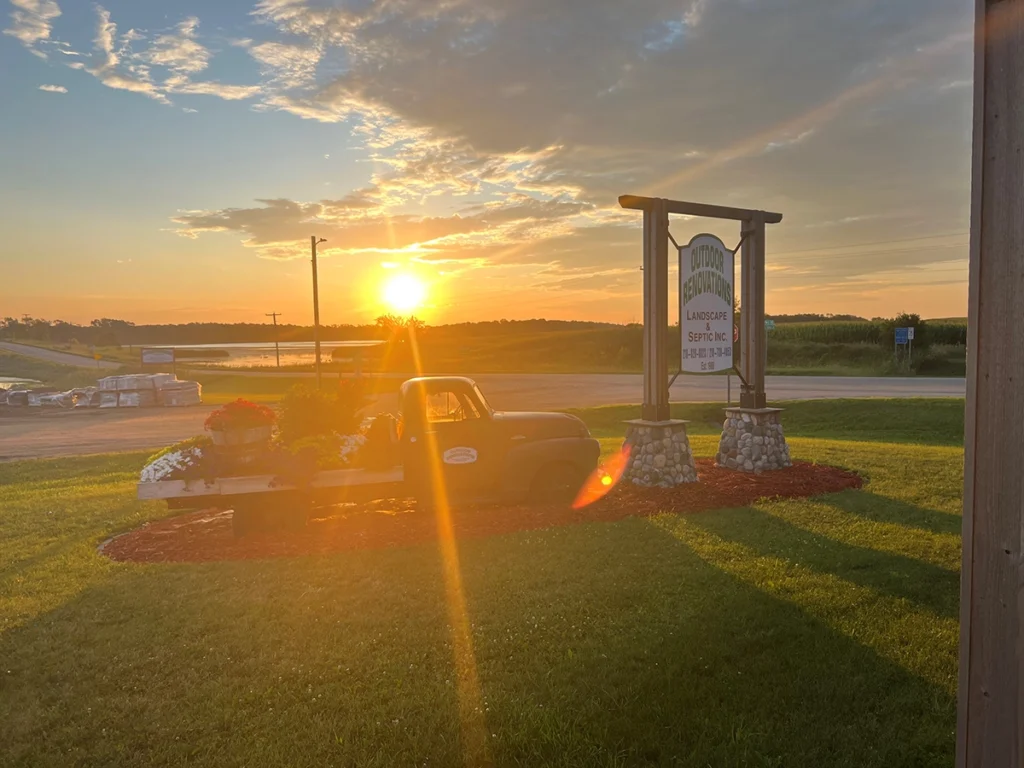 Outdoor Renovation sign and truck in front of a beautiful sunset